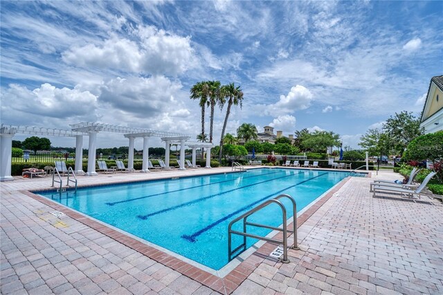 2333 Pinehurst Ct, Davenport, FL 33837 - community pool featuring a pergola and a patio