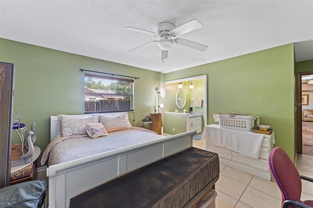 1096 Dyson Dr, Winter Springs, FL 32708 - bedroom featuring light tile patterned flooring, a textured ceiling, ceiling fan, and connected bathroom