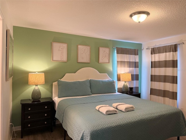 2514 Dharma Cir, Kissimmee, FL 34746 - bedroom featuring wood finished floors and a textured ceiling