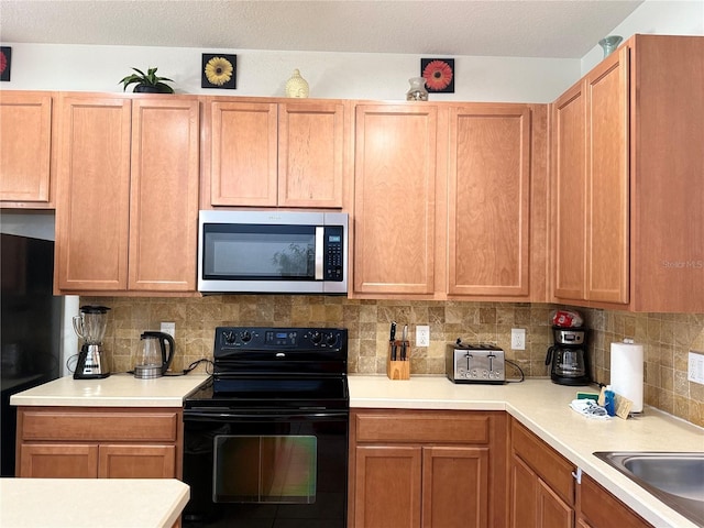 2514 Dharma Cir, Kissimmee, FL 34746 - kitchen with black appliances, light countertops, and tasteful backsplash