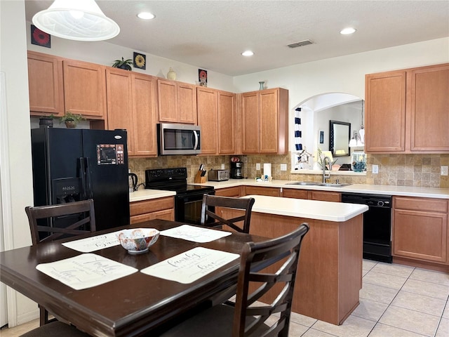 2514 Dharma Cir, Kissimmee, FL 34746 - kitchen featuring black appliances, a sink, backsplash, light countertops, and recessed lighting