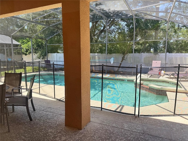 2514 Dharma Cir, Kissimmee, FL 34746 - view of swimming pool with a fenced backyard, a patio area, a pool with connected hot tub, and glass enclosure