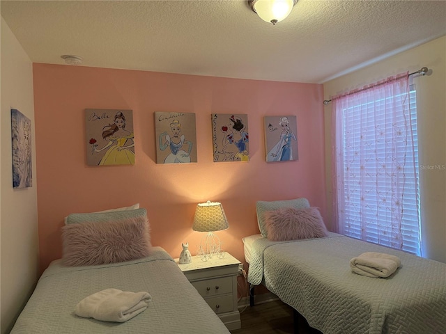 2514 Dharma Cir, Kissimmee, FL 34746 - bedroom with a textured ceiling and dark wood-style flooring