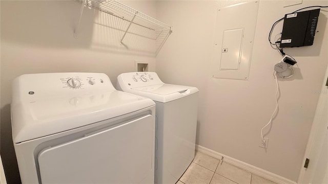 8517 Bay Lilly Loop, Kissimmee, FL 34747 - laundry room with electric panel, washing machine and dryer, light tile patterned floors, and baseboards