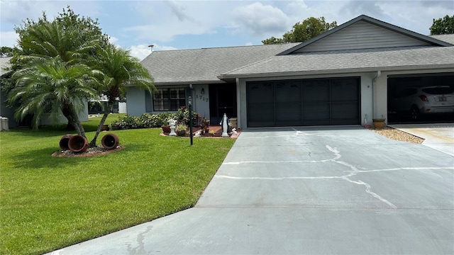 1717 W Orangewood Ln, Avon Park, FL 33825 - ranch-style home featuring a garage, concrete driveway, a front lawn, and a shingled roof