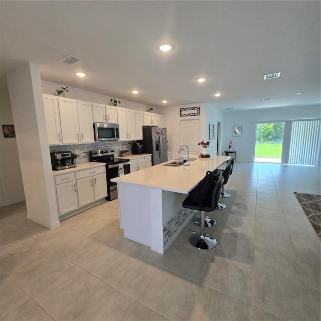 200 Citrine Loop, Kissimmee, FL 34758 - kitchen featuring appliances with stainless steel finishes, a sink, decorative backsplash, white cabinets, and recessed lighting