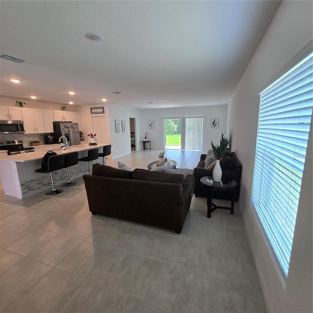 200 Citrine Loop, Kissimmee, FL 34758 - living room featuring light tile patterned floors, recessed lighting, and baseboards