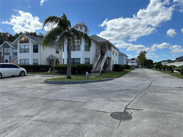 2734 Rio Grande Trl Unit 2734, Kissimmee, FL 34741 - view of building exterior with stairs, a residential view, and uncovered parking