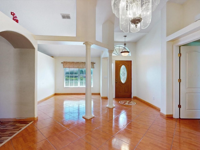 3811 Gator Bay Ln, Saint Cloud, FL 34772 - entryway featuring a chandelier, ornate columns, baseboards, and a towering ceiling