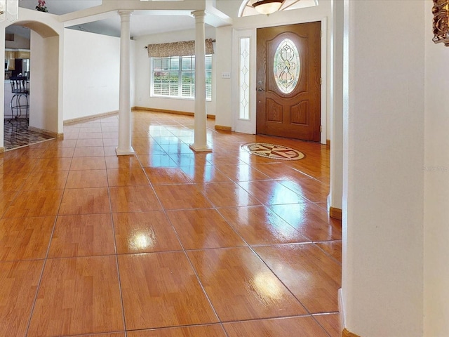 3811 Gator Bay Ln, Saint Cloud, FL 34772 - foyer entrance with decorative columns, arched walkways, wood finished floors, and baseboards