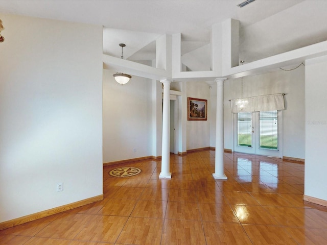 3811 Gator Bay Ln, Saint Cloud, FL 34772 - spare room featuring decorative columns, baseboards, a towering ceiling, and tile patterned floors
