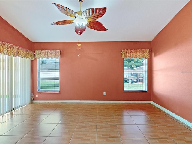 3811 Gator Bay Ln, Saint Cloud, FL 34772 - tiled empty room with healthy amount of natural light, ceiling fan, and baseboards