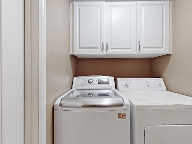 3811 Gator Bay Ln, Saint Cloud, FL 34772 - laundry room featuring washer and clothes dryer and cabinet space