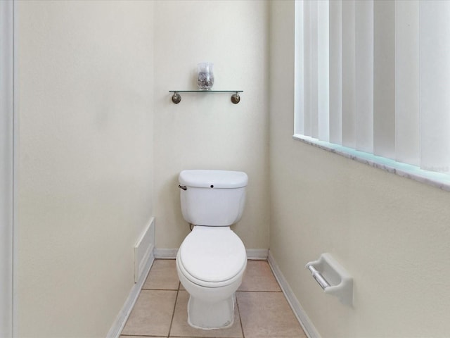 3811 Gator Bay Ln, Saint Cloud, FL 34772 - bathroom featuring toilet, tile patterned flooring, and baseboards