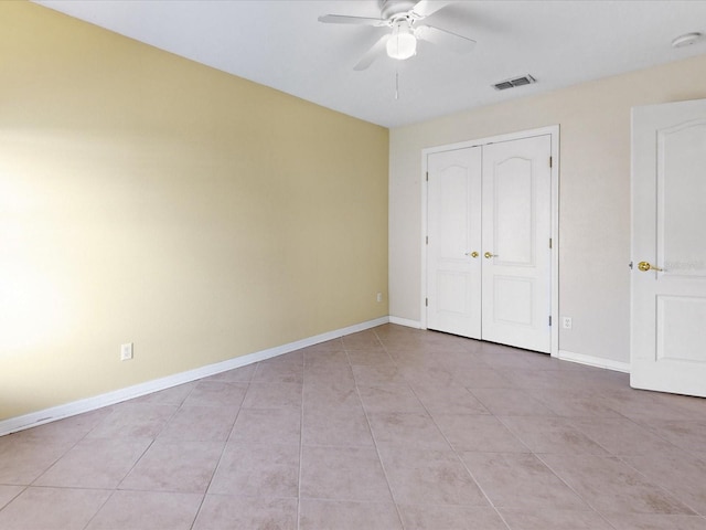 3811 Gator Bay Ln, Saint Cloud, FL 34772 - unfurnished bedroom with baseboards, light tile patterned floors, a closet, and ceiling fan