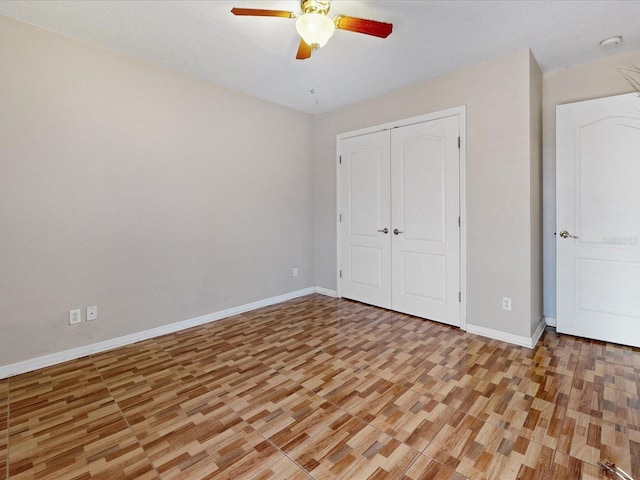 3811 Gator Bay Ln, Saint Cloud, FL 34772 - unfurnished bedroom featuring light wood finished floors, baseboards, a closet, and ceiling fan