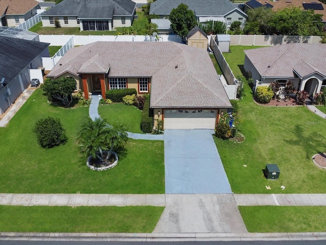 3811 Gator Bay Ln, Saint Cloud, FL 34772 - view of front of property featuring concrete driveway, an attached garage, a residential view, a front lawn, and roof with shingles