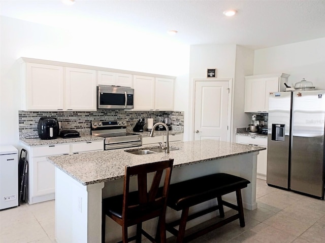 409 Conway Ave, Saint Cloud, FL 34771 - kitchen with appliances with stainless steel finishes, a sink, light tile patterned floors, and backsplash