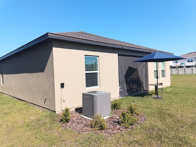 409 Conway Ave, Saint Cloud, FL 34771 - view of side of property featuring central AC unit, a lawn, and stucco siding