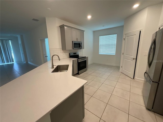 4053 Redbridge Loop, Davenport, FL 33837 - kitchen featuring appliances with stainless steel finishes, a sink, gray cabinets, light countertops, and light tile patterned floors