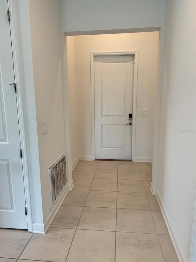 4053 Redbridge Loop, Davenport, FL 33837 - corridor featuring light tile patterned flooring and baseboards