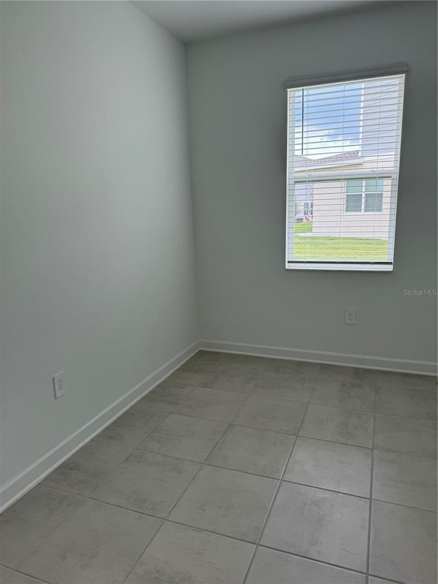 4053 Redbridge Loop, Davenport, FL 33837 - empty room with baseboards and light tile patterned flooring