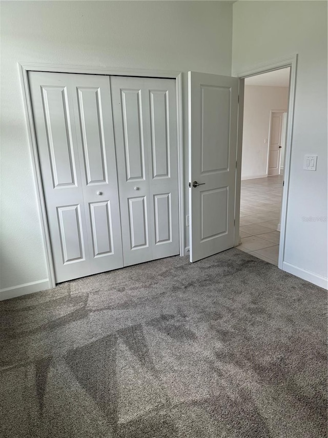 4053 Redbridge Loop, Davenport, FL 33837 - unfurnished bedroom featuring carpet, a closet, and baseboards
