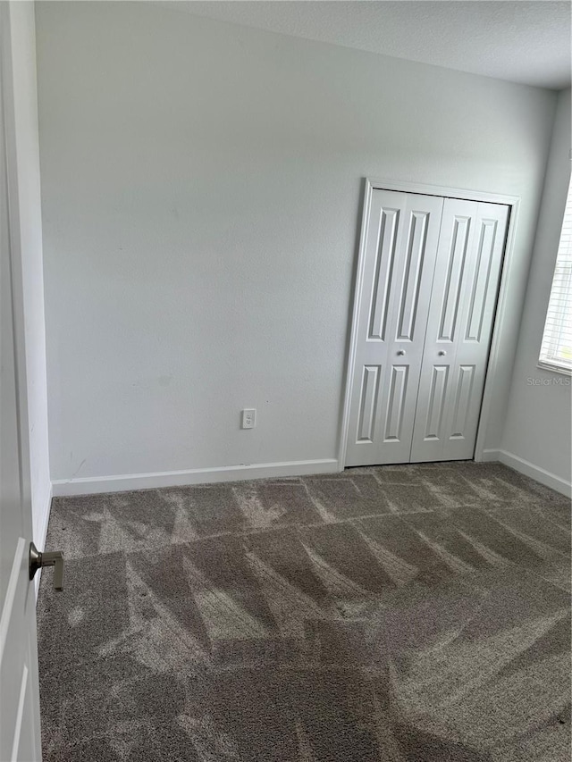 4053 Redbridge Loop, Davenport, FL 33837 - unfurnished bedroom featuring carpet, baseboards, and a closet