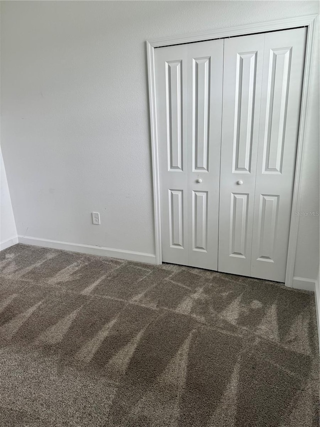 4053 Redbridge Loop, Davenport, FL 33837 - unfurnished bedroom with carpet, baseboards, and a closet