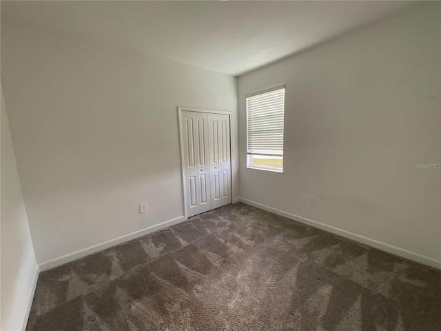 4053 Redbridge Loop, Davenport, FL 33837 - unfurnished room with dark carpet and baseboards