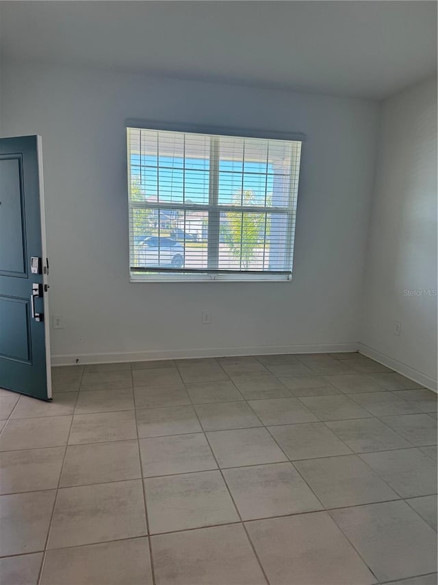 4053 Redbridge Loop, Davenport, FL 33837 - spare room featuring light tile patterned floors and baseboards