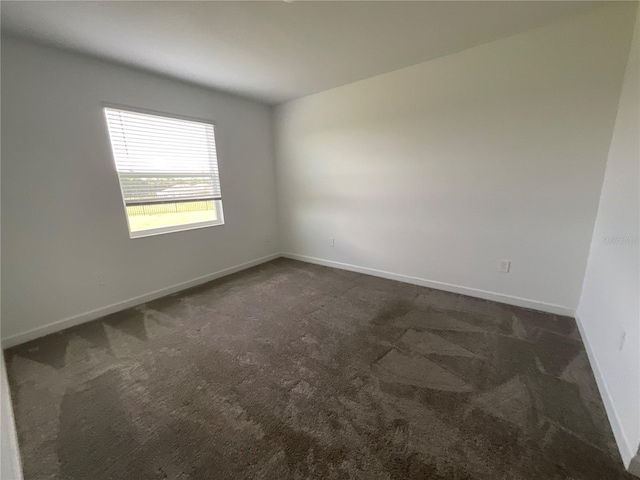 4053 Redbridge Loop, Davenport, FL 33837 - empty room with dark carpet and baseboards