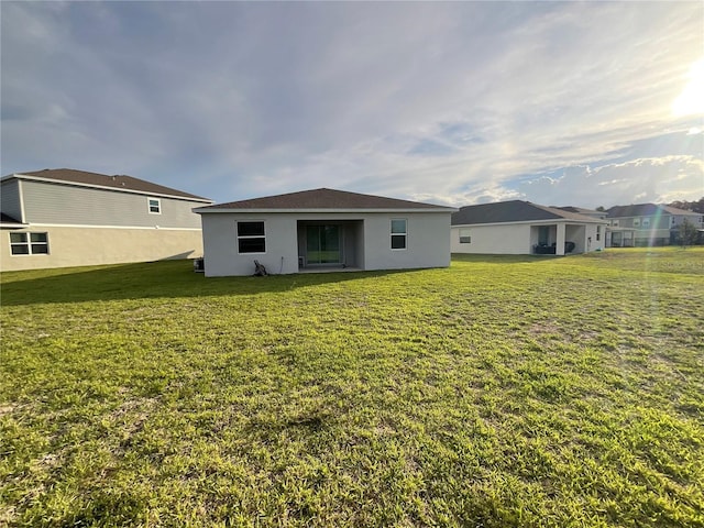 4053 Redbridge Loop, Davenport, FL 33837 - back of property featuring a yard and stucco siding