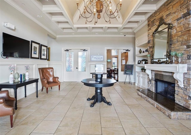 4053 Redbridge Loop, Davenport, FL 33837 - living area with a chandelier, a towering ceiling, a fireplace, crown molding, and a decorative wall