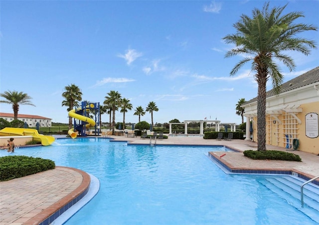 4053 Redbridge Loop, Davenport, FL 33837 - community pool with a water slide, a pergola, and a patio