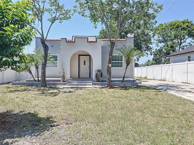 2409 E Magnolia St, Lakeland, FL 33801 - mediterranean / spanish house with stucco siding and a chimney