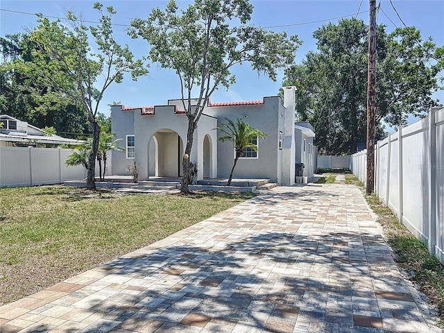 2409 E Magnolia St, Lakeland, FL 33801 - mediterranean / spanish-style home with stucco siding, driveway, and a chimney