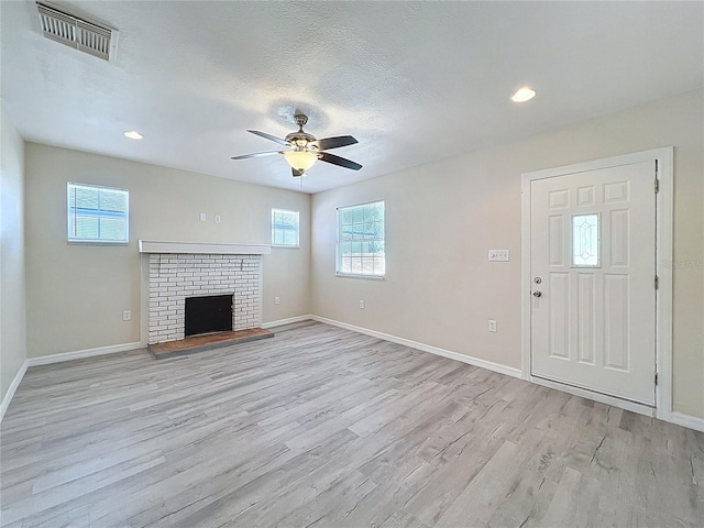 2409 E Magnolia St, Lakeland, FL 33801 - unfurnished living room with light wood-style floors, plenty of natural light, a ceiling fan, baseboards, and recessed lighting