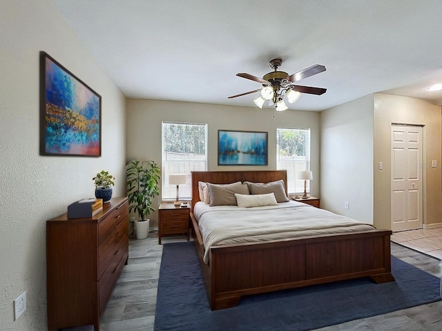 2409 E Magnolia St, Lakeland, FL 33801 - bedroom featuring multiple windows, a ceiling fan, wood finished floors, and a textured wall