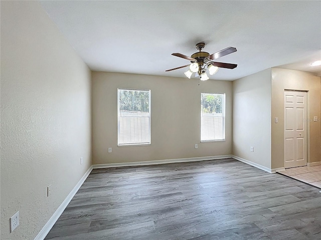 2409 E Magnolia St, Lakeland, FL 33801 - unfurnished room with a ceiling fan, wood finished floors, and baseboards