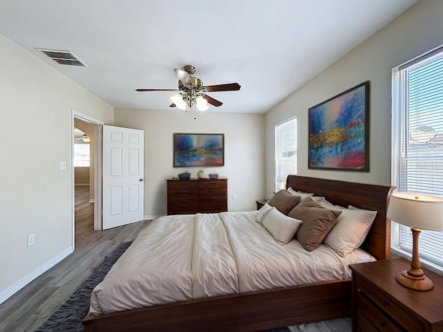 2409 E Magnolia St, Lakeland, FL 33801 - bedroom with wood finished floors, baseboards, and ceiling fan