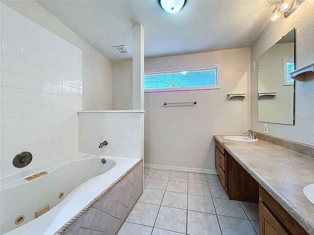 2409 E Magnolia St, Lakeland, FL 33801 - full bath featuring a tub with jets, plenty of natural light, double vanity, and tile patterned floors
