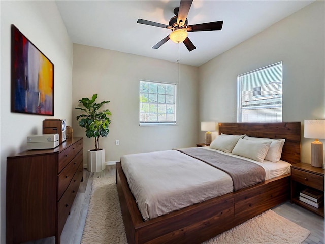 2409 E Magnolia St, Lakeland, FL 33801 - bedroom with light wood-style floors, a ceiling fan, and baseboards
