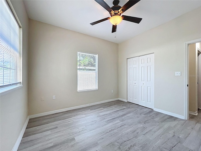2409 E Magnolia St, Lakeland, FL 33801 - unfurnished bedroom with light wood-type flooring, baseboards, a closet, and a ceiling fan