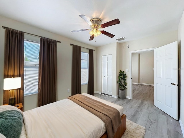 2409 E Magnolia St, Lakeland, FL 33801 - bedroom featuring light wood-style floors, ceiling fan, a closet, and baseboards