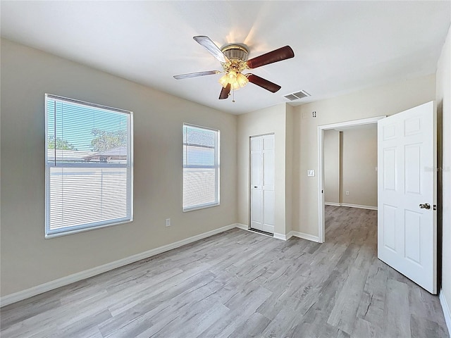2409 E Magnolia St, Lakeland, FL 33801 - unfurnished bedroom featuring light wood-style floors, a closet, baseboards, and a ceiling fan