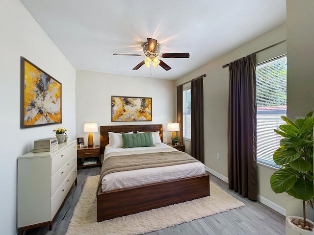 2409 E Magnolia St, Lakeland, FL 33801 - bedroom featuring wood finished floors, baseboards, and ceiling fan