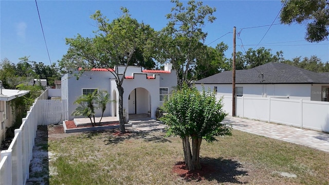 2409 E Magnolia St, Lakeland, FL 33801 - view of front of home featuring stucco siding, a tiled roof, and a chimney