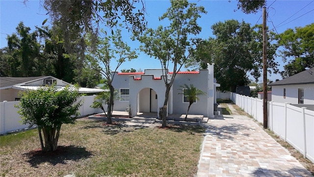 2409 E Magnolia St, Lakeland, FL 33801 - mediterranean / spanish house with stucco siding and a chimney