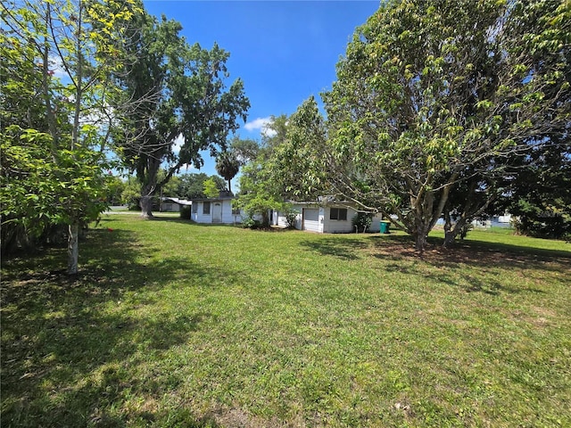 2704 Sample St, Kissimmee, FL 34744 - view of grassy yard featuring a garage
